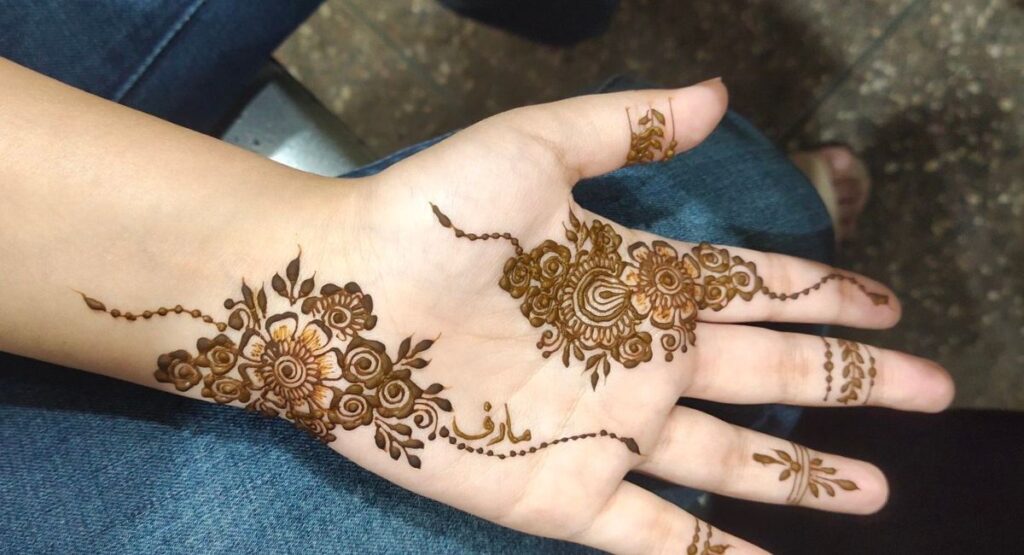 Front hand simple mehndi design with elegant and minimal henna patterns on female hand for festive look