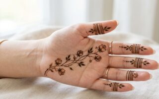 Simple front hand mehndi design with delicate floral details