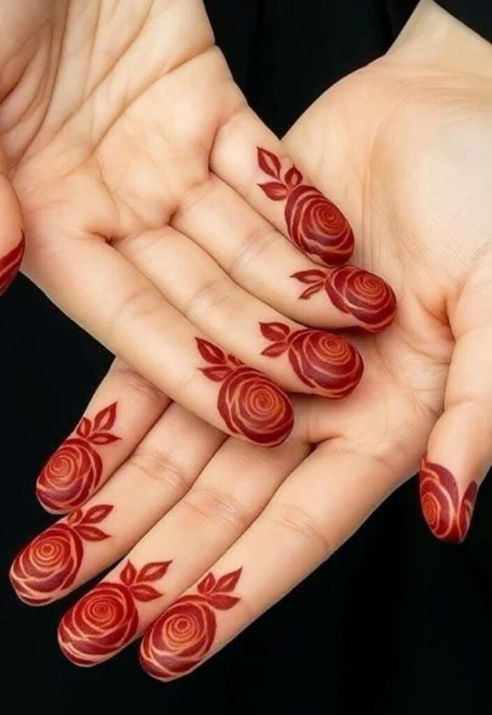 Finger tip floral mehndi patterns with small delicate flower motifs on each fingertip, minimal henna design, clean and elegant spacing, modern 2026 simple floral mehndi style on female hands.