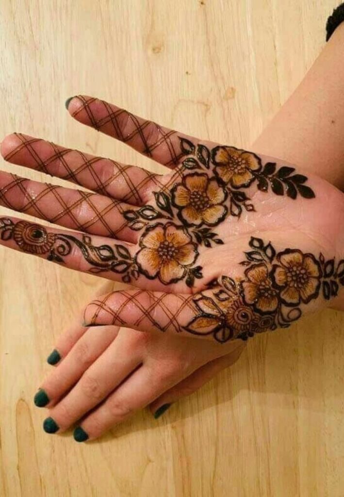 Half palm net mehndi design with crisscross pattern and floral accents