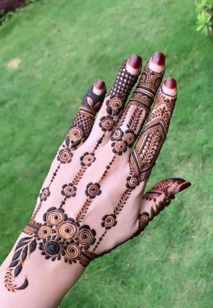 Hand harness bridal mehndi design with modern jewelry style henna artwork