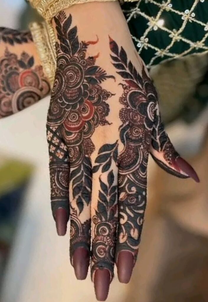 Indo-Arabic Bakra Eid mehndi design 2026 with paisley, floral, and mesh patterns on front hand.