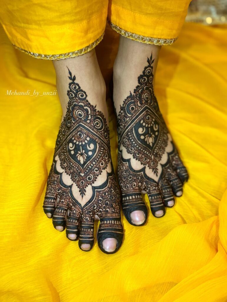 “Heavy bridal foot henna design perfect for wedding ceremony look”