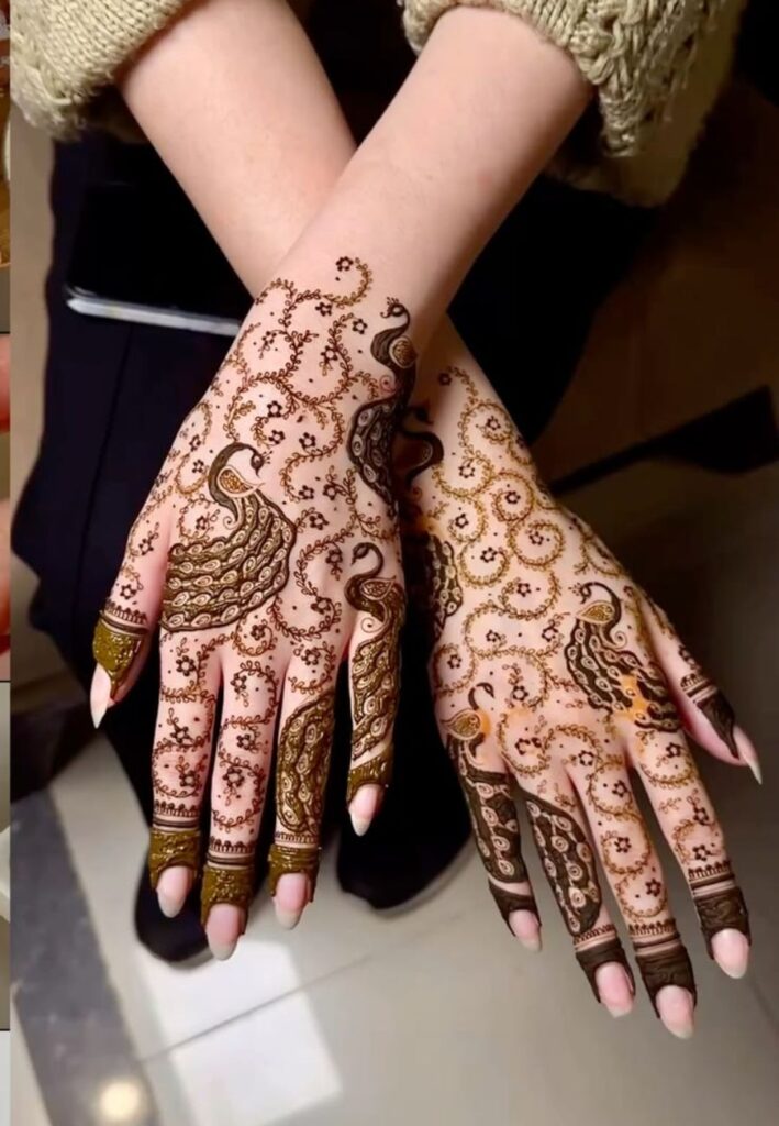 Peacock accent bridal mehndi design with elegant traditional detailing and modern bridal style