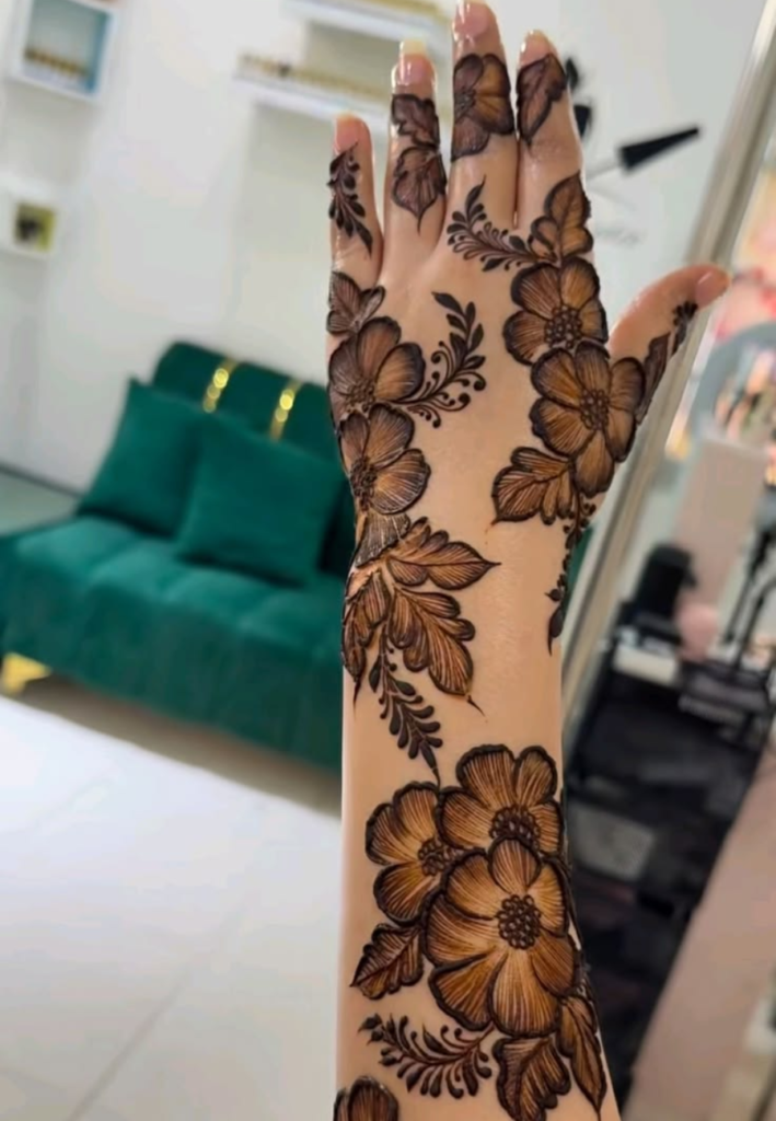 Classic Rose Trail Gulf Style Floral Henna design featuring bold rose flowers connected with elegant flowing vines and Arabic mehndi patterns on hands