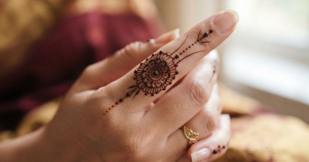 Minimal fingertip mehndi design with simple henna patterns