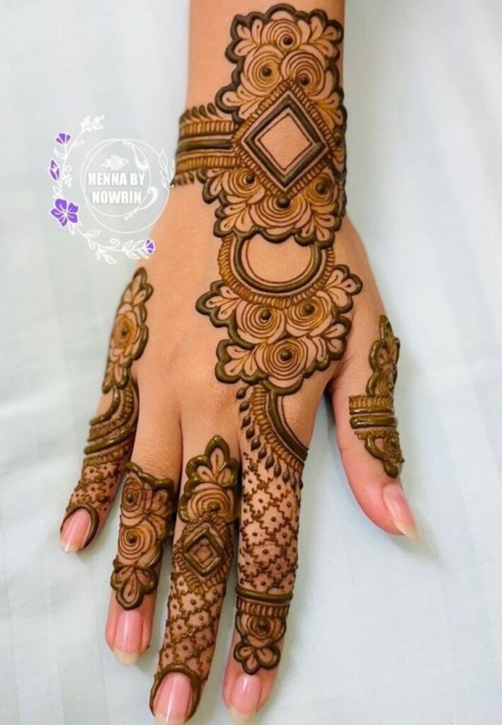 Moroccan bracelet style mehndi design with geometric patterns on wrist and hand.