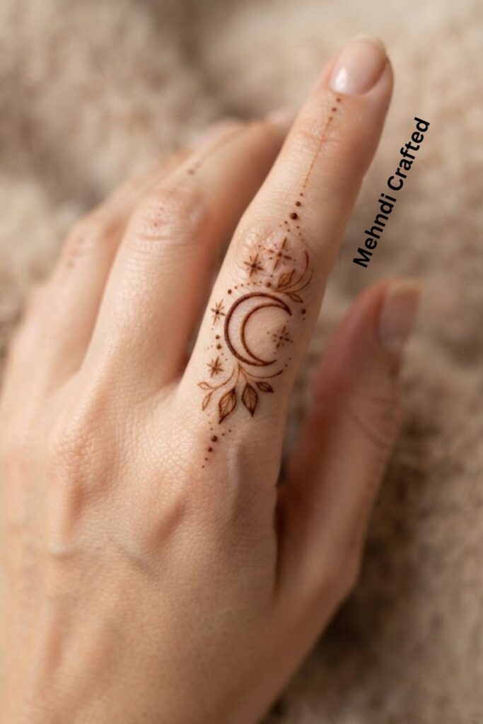 Crescent Moon Finger Henna Design with delicate stars and minimal henna details