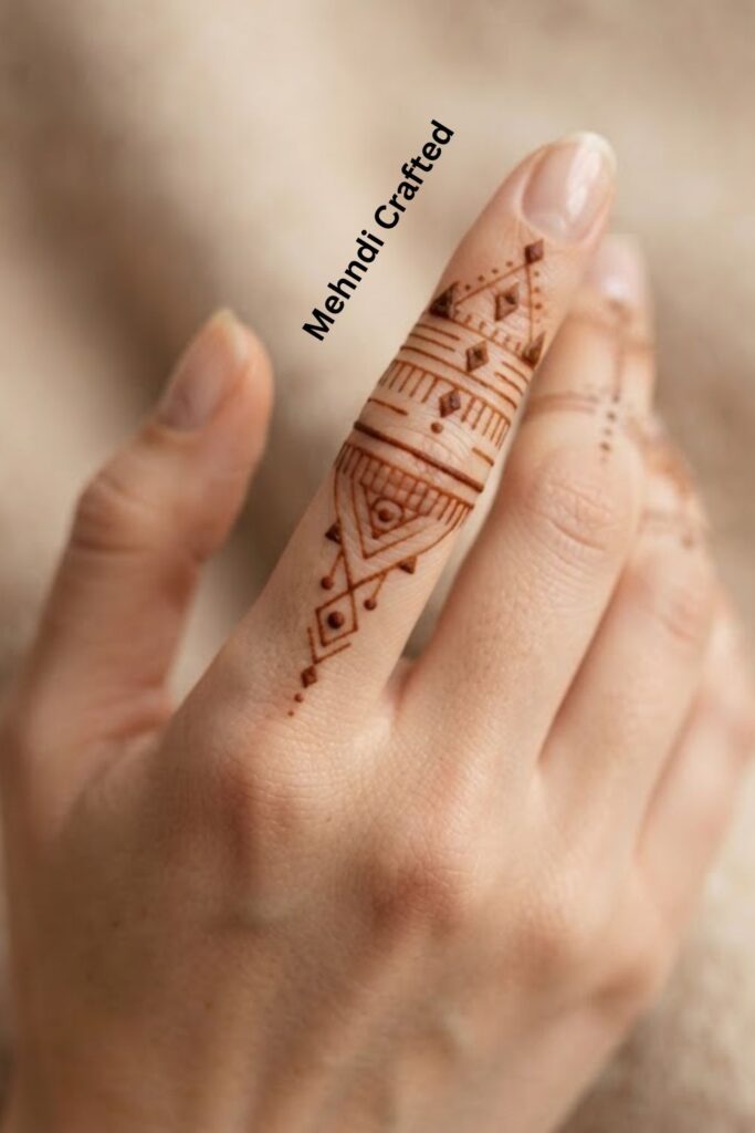 Geometric Finger Henna Tattoo with delicate diamonds, lines, dots, and symmetrical patterns