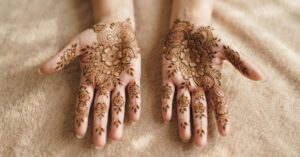 Indian floral mehndi designs 2026 with detailed flowers and leafy patterns covering the palms and fingers.
