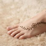 Minimal Foot Mehndi Designs 2026 with a simple floral and leafy foot pattern