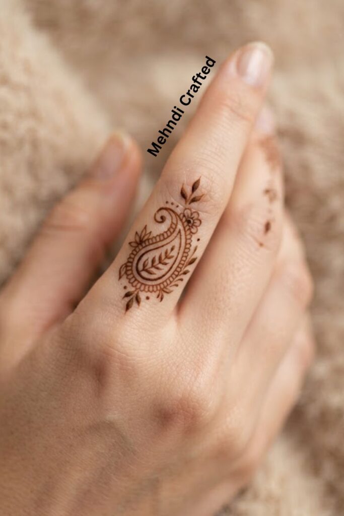 Tiny Paisley Finger Henna Design with a delicate minimal paisley motif